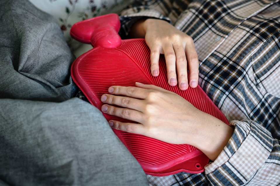 Person holding a hot water bottle.